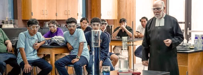 students and teacher in chemistry class