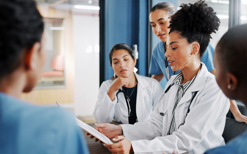 a group of doctors discussing a patient's chart