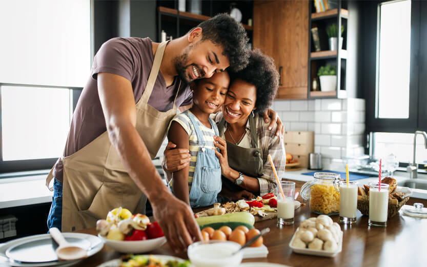 a family of three preparing a healthy meal together