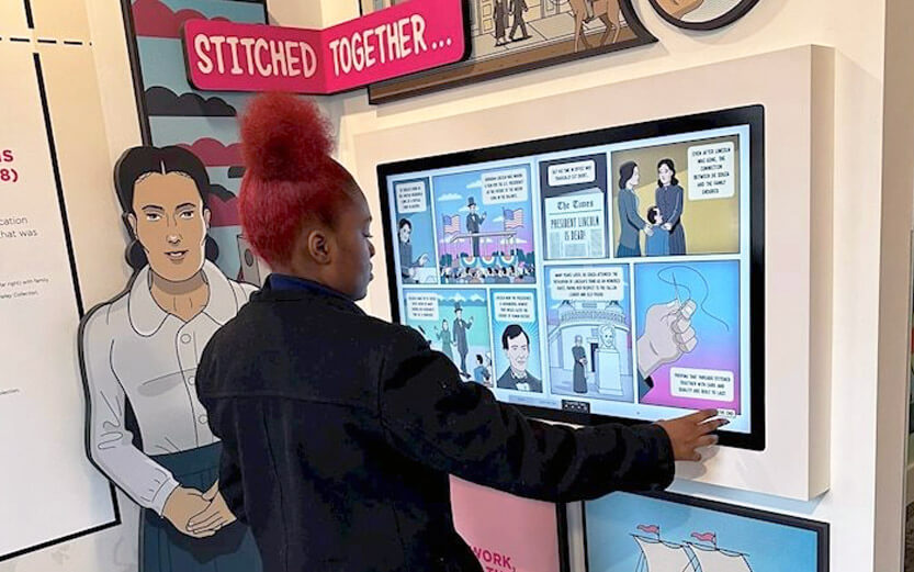 a woman interacting with an exhibit on Abraham Lincoln