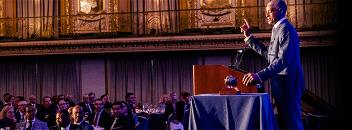 a speaker wearing a suit at an event