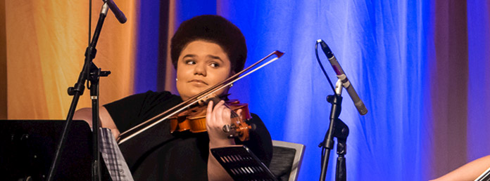 a violinist performing on stage
