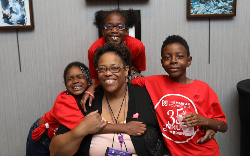 three children with woman smiling