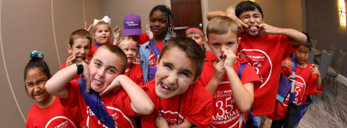 kids in red shirts making faces