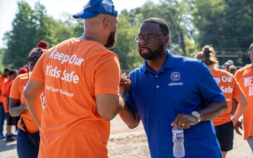 two men at an event shaking hands