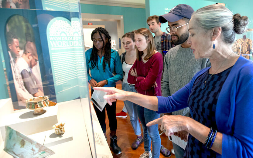 a teacher guiding her students through a museum