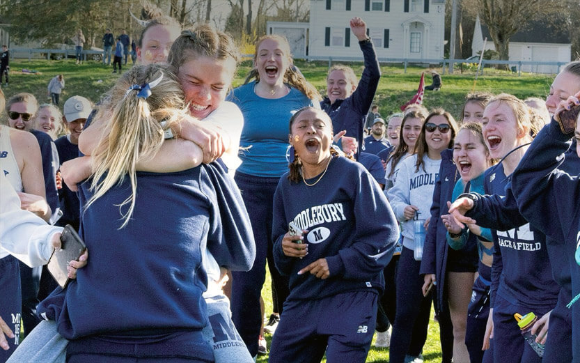 the womens' track and field team celebrating