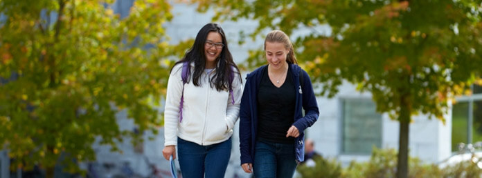 two female college students walking and talking