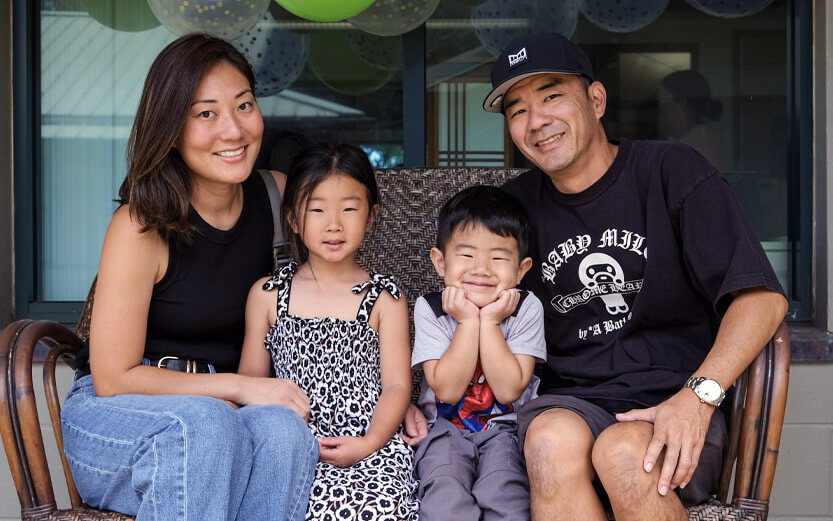 family of four smiling
