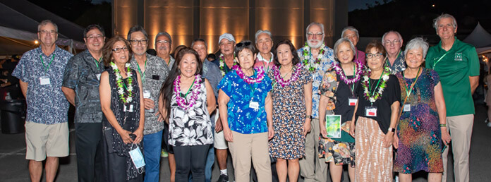 group of people wearing Hawaiian clothes
