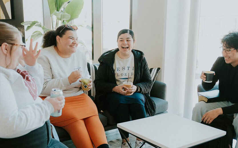 students sitting in a circle laughing