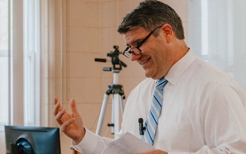teacher gesturing and smiling