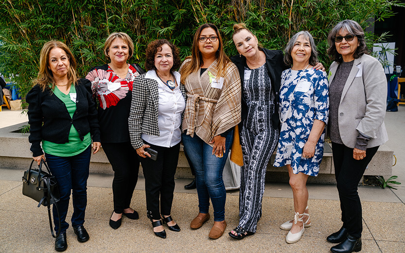 Group of women at a convention posing for a picture