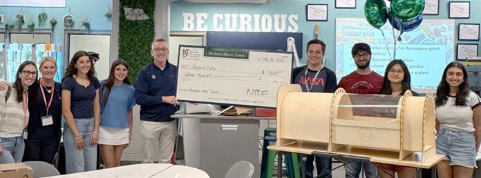 the presentation of a check to a group of students