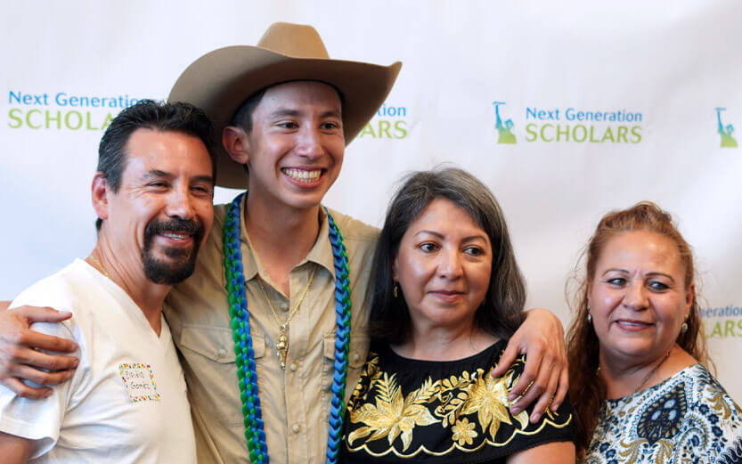 a family of four posing for a photo at an event