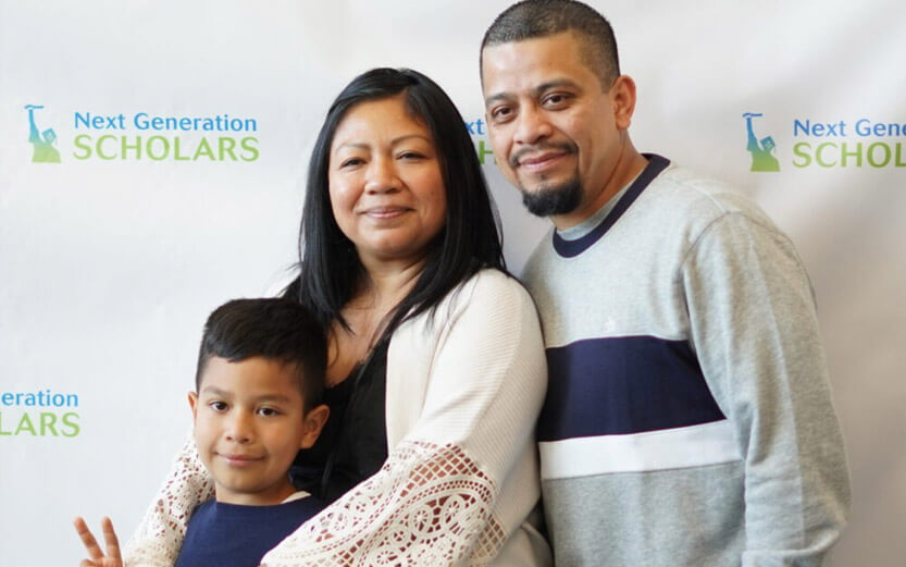 a family of three posing for a photo at an event