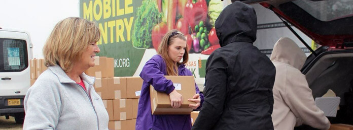 mobile pantry volunteers loading the back of a car
