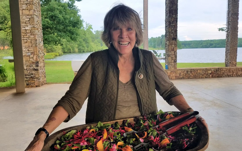 woman holding a salad platter