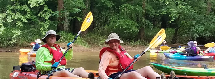 people canoeing on a river