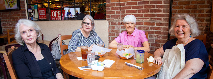 four senior women at lunch