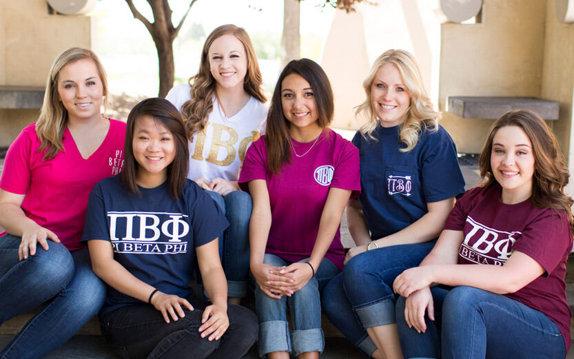 group of Pi Beta Phi members seated on steps smiling