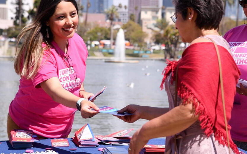 a Planned Parenthood volunteer handing out literature at an event