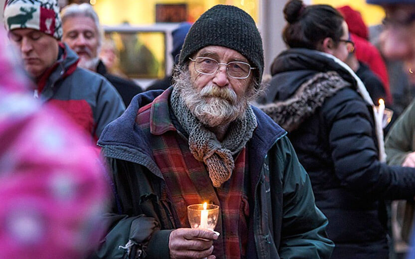 senior veteran holding a candle at an event