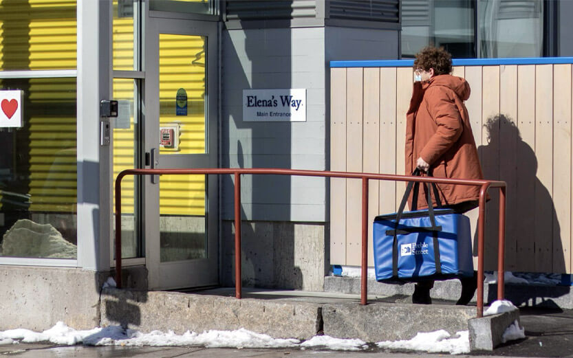 woman delivering a large insulated food bag