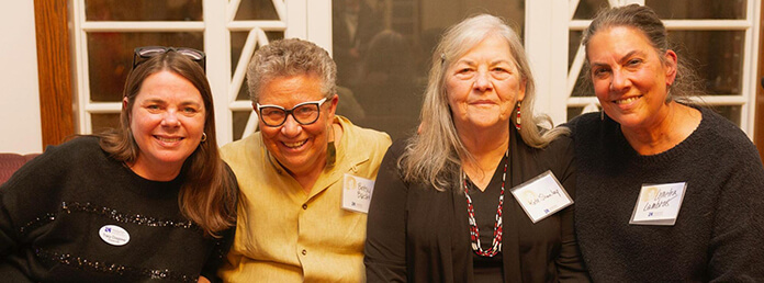 A group of women at an event posing for a picture