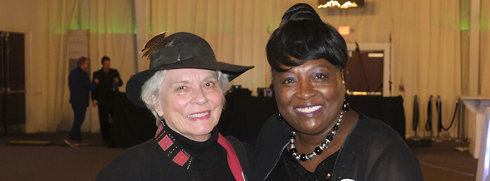 two women at an event posing for a picture