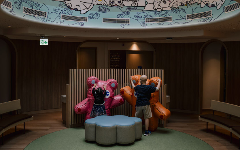 two kids playing with large inflatable bears