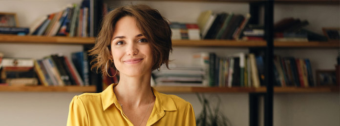 woman in a yellow shirt smiling