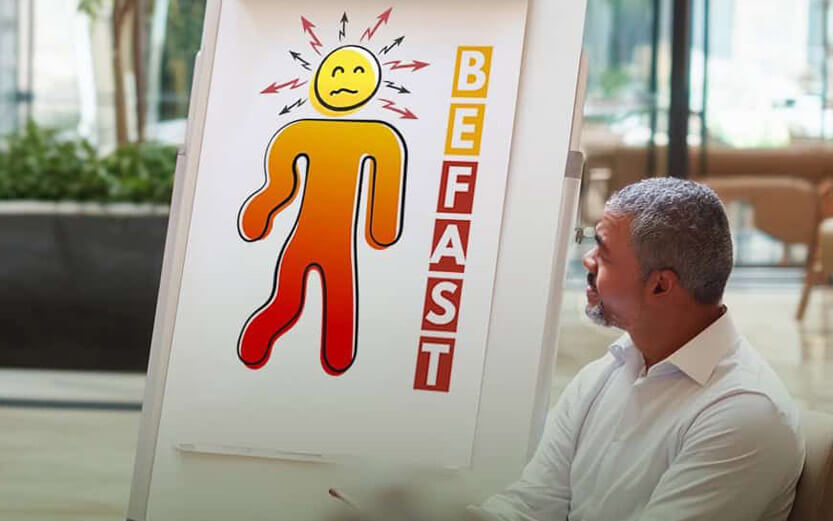 a man looking at a BEFAST poster