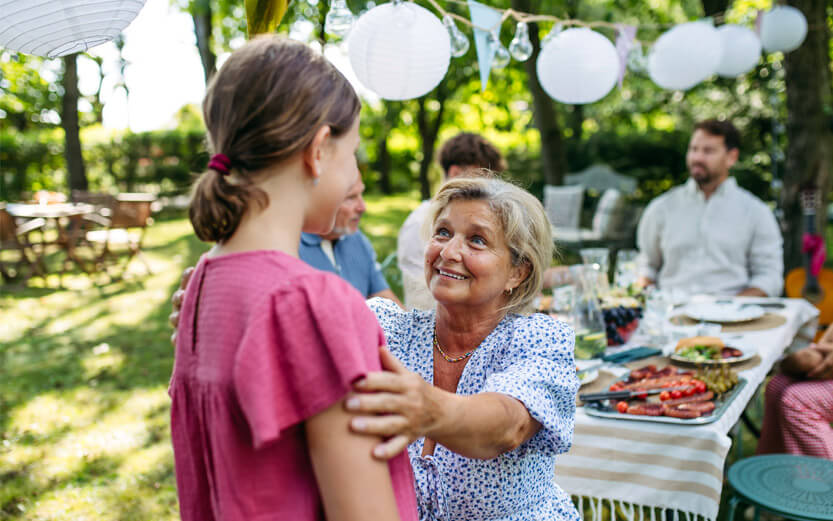 a woman enjoying spending time with family members at an outdoor barbecue