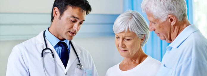 two seniors talking to their doctor
