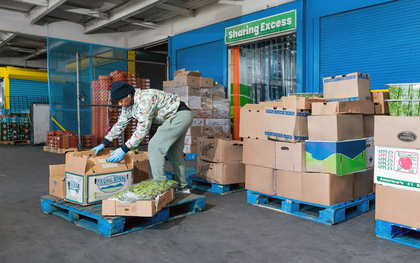 a warehouse dock working sorting through produce