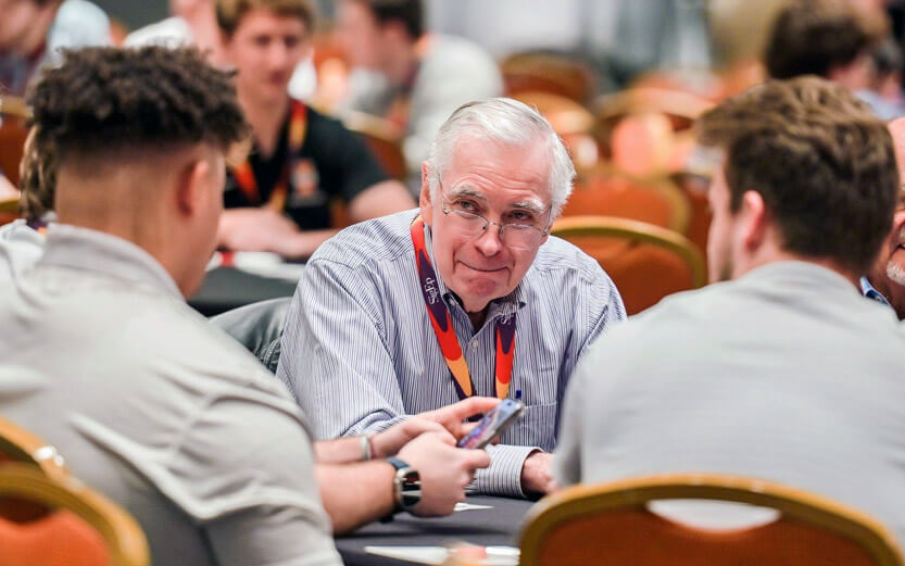 Sigma Phi Epsilon alumnus at an eent talking with students