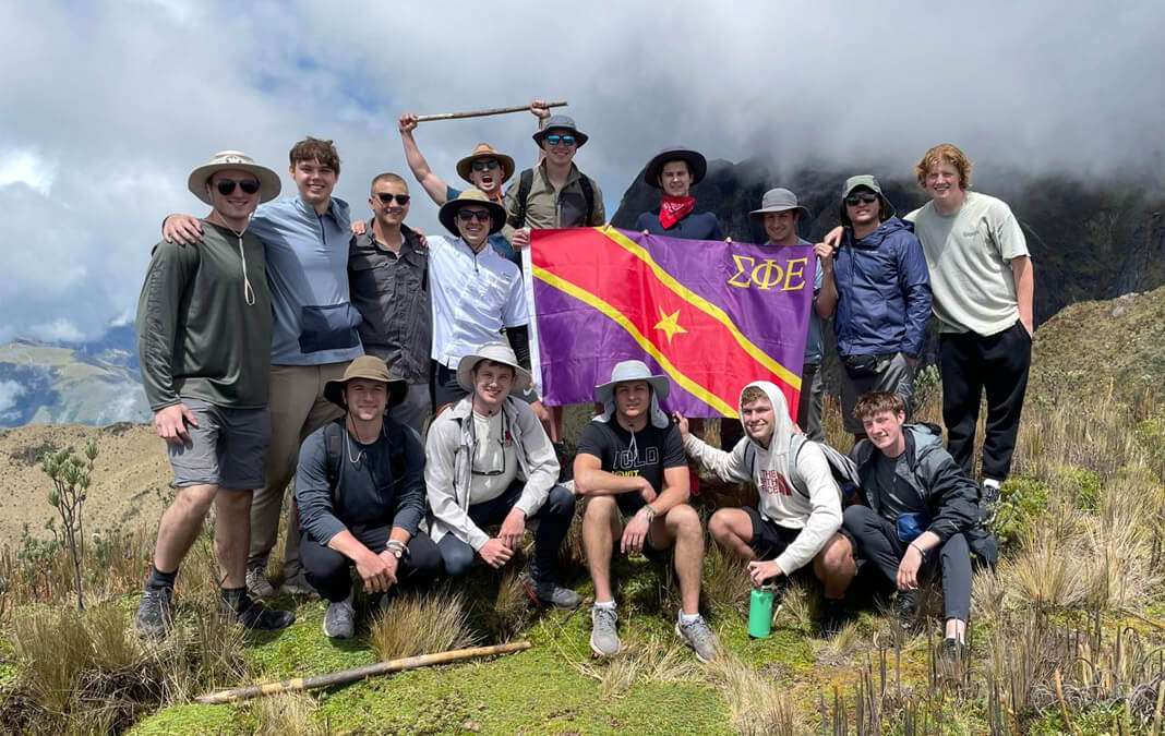 Sigma Phi Epsilon hiking group holding up their flag