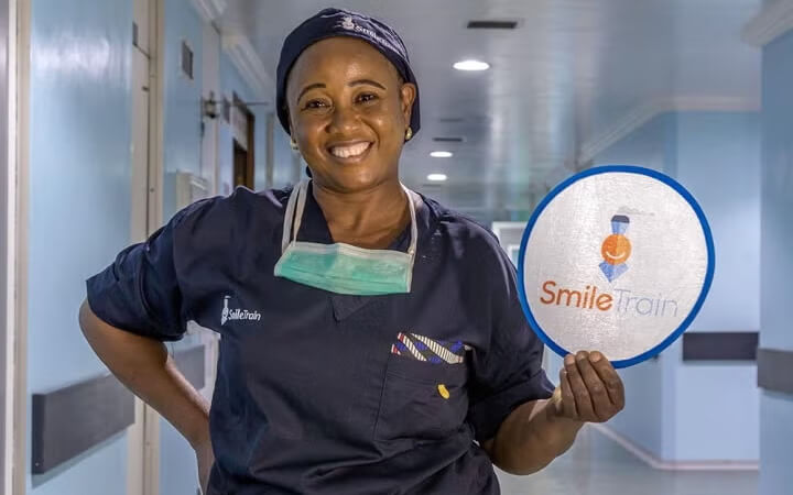 Doctor posing with charity sign