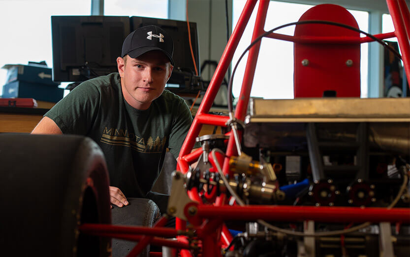 a mechanics student working on a race car