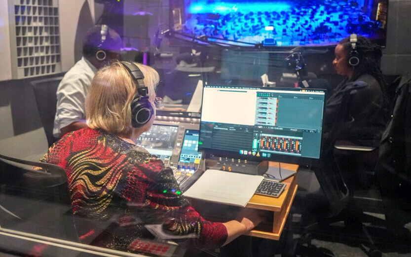 an interview taking place in a radion station sound booth