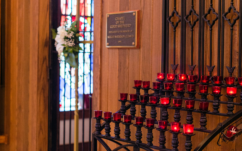 lit candles outside a chapel