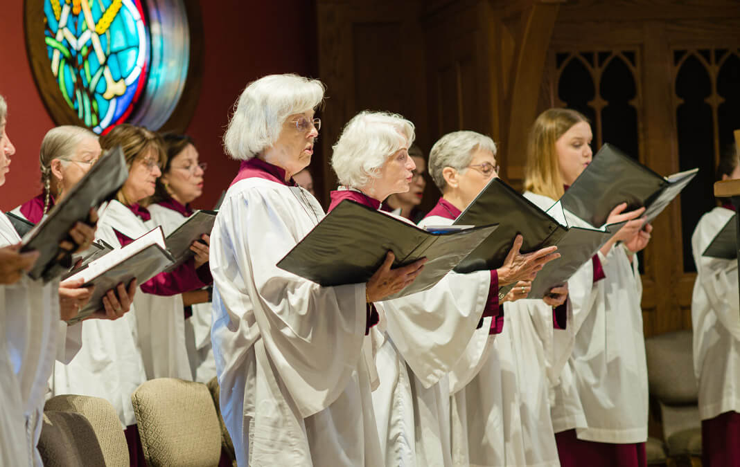 women's choir singing in church wearing white robes