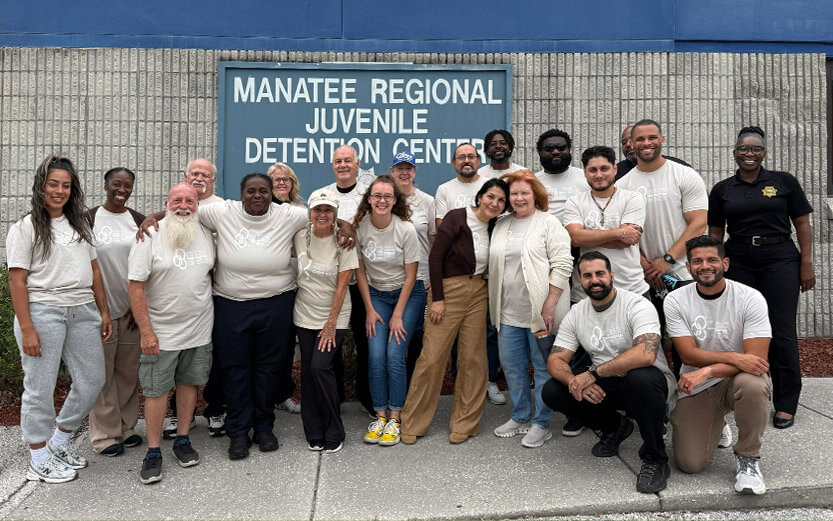 a group of people posing for a photo in front of the Manatee Regional Juvenile Detention Center