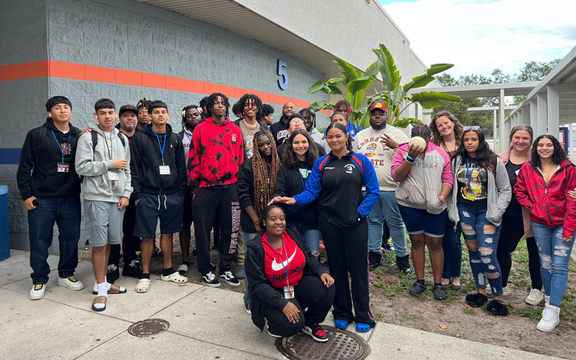 a group of high school students and mentors posing for a photo