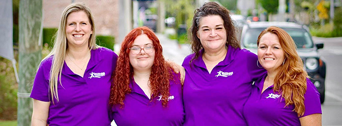 Group of women in matching shirts posing for a photo