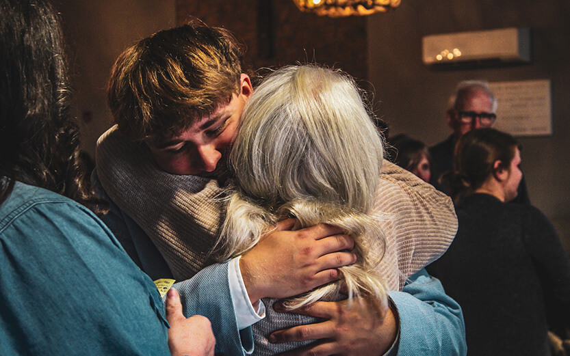 Mother and son embracing