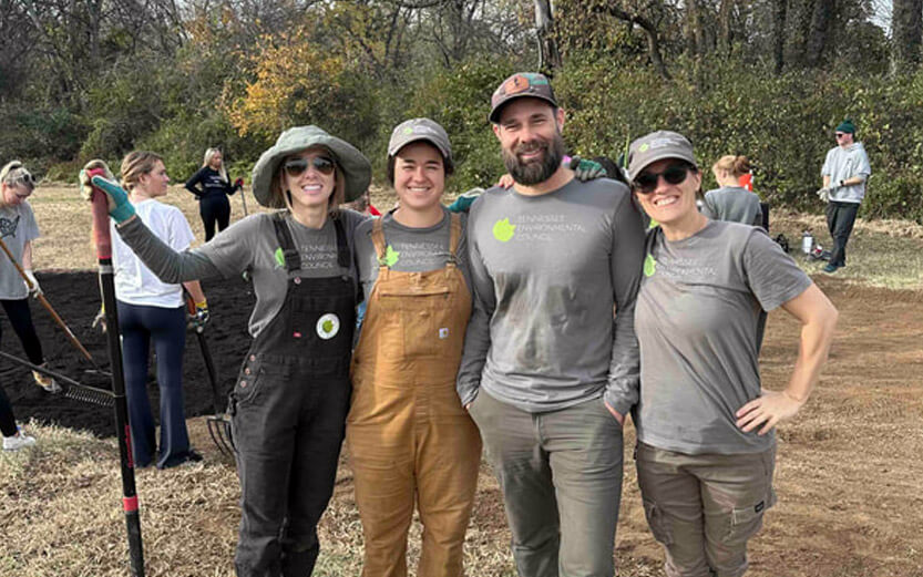 group of four volunteers smiling