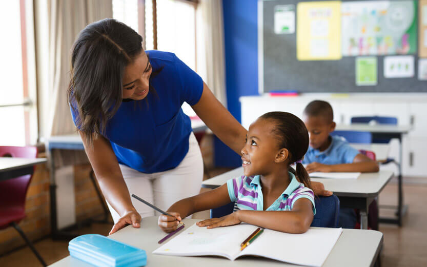 a teacher helping a young student