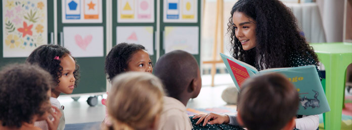 a preschool teacher reading to students